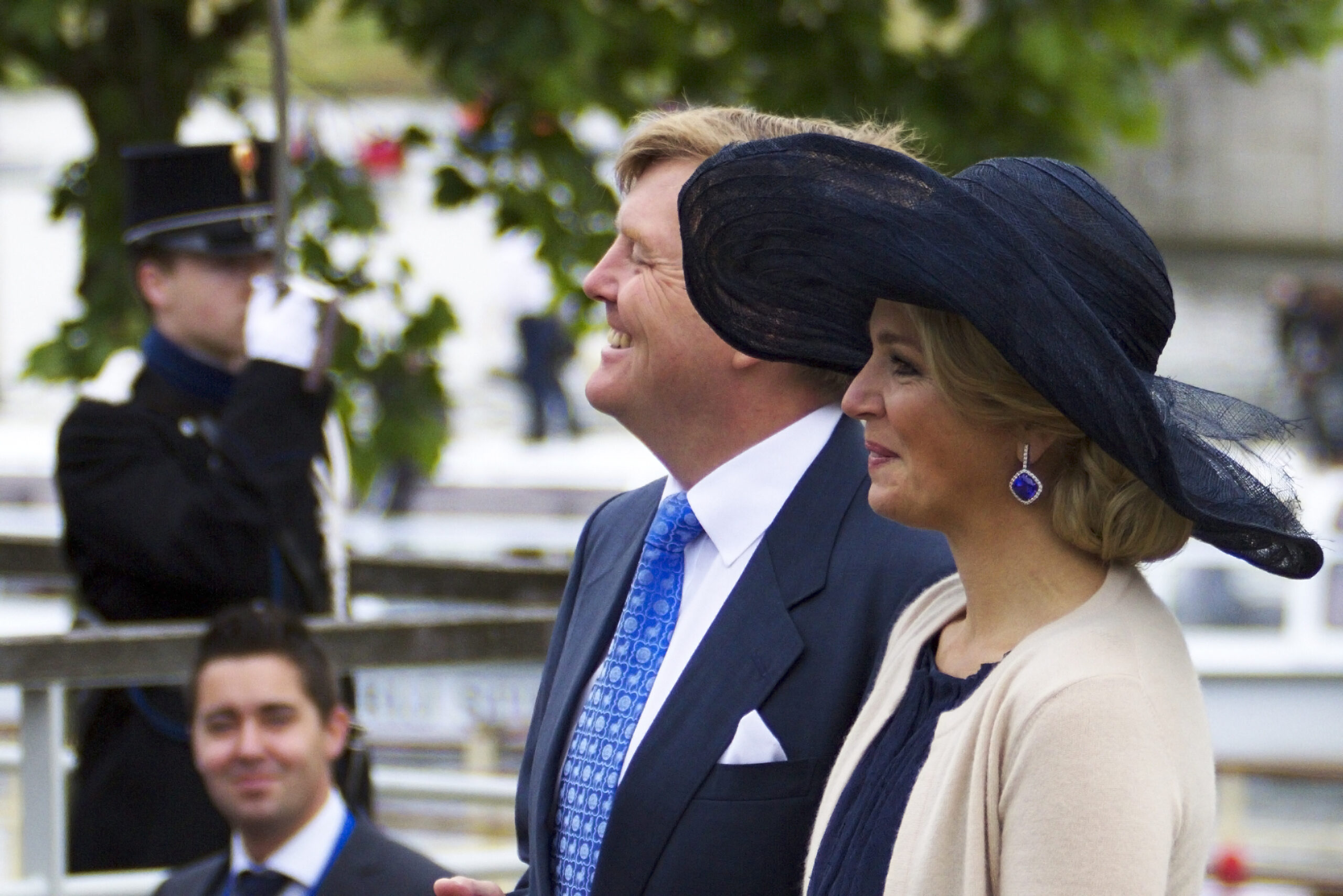 the queen and king of the Netherlands in a suit and tie